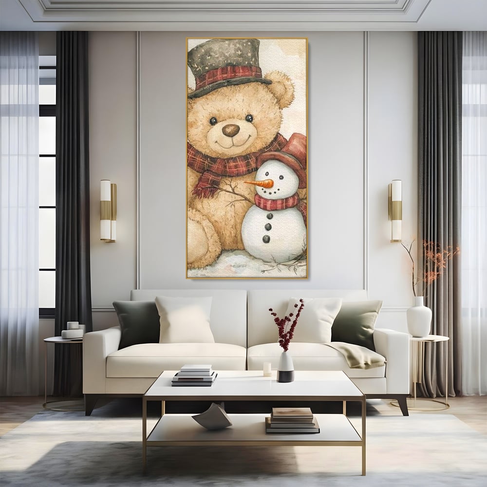 Tablou canvas cu ilustratie cu ursulet si om de zapada, in rama de aluminiu auriu, pe perete intr-un living